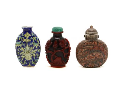 A group of three Chinese snuff bottles,20th century, comprising:a famille rose example, with scrolling lotus in yellow and gr