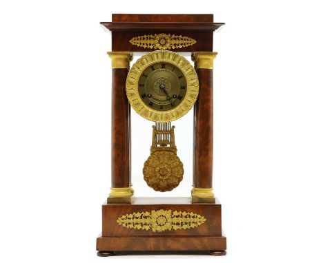 A mahogany portico clock, in the Empire style, with cast gilt details, painted Roman numerals, with a cast pendulum, 23cm wid