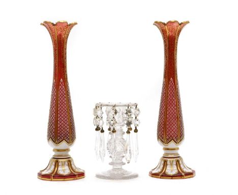 A pair of Bohemian ruby and opal cased glass vases,c.1870, the lobed rims over a slender oviform body with gilt decoration an