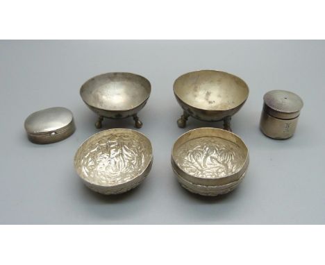 Two silver boxes, one with screw top, two white metal salts with Nile scene decoration and a white metal box with elephant de