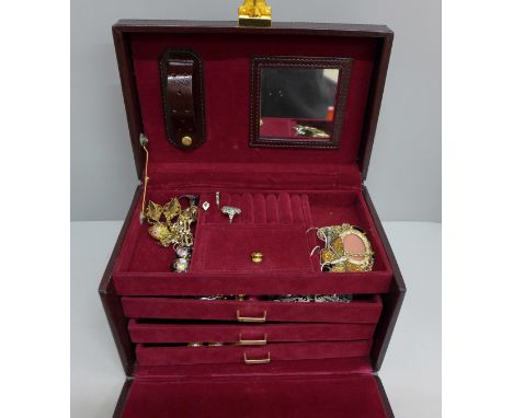 A jewellery case and contents, including two gold rings and a brooch, a silver gate bracelet and silver rings 