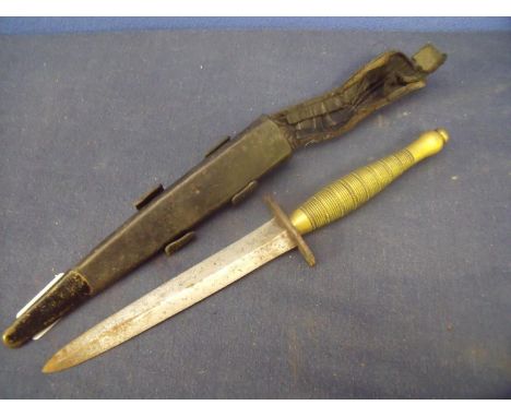 Unusual Fairbairn-Sykes style commando knife with 6 1/4 inch double edged blade, steel crosspiece and ribbed brass grip stamp
