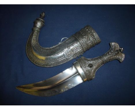 Circa 1900 Saudi Arabian Jambiya/Khanjar, the hilt and scabbard covered overall with finely decorated white metal in geometri