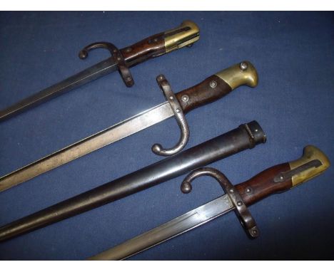 Three French 1874 sword bayonets, one with scabbard with inscriptions to the back straps and dates of 1876 &amp; 1879 (3) 