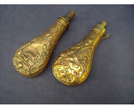 Brass and copper bodied powder flask with embossed deer hunting scenes within oak leaves and another similar flask with oak l