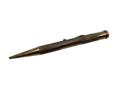 A 9ct gold propelling pencil with engine turned decoration. 
