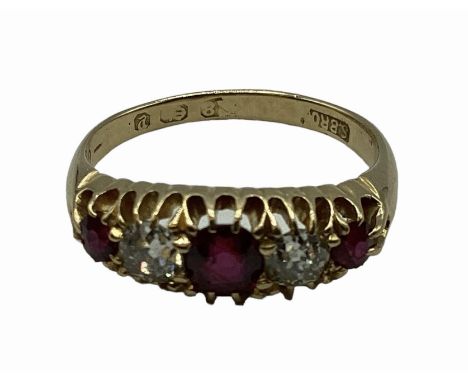 An 18 carat gold Ruby and diamond ring, 3 round free cut rubies set with two old cut diamonds, 3g  size L 