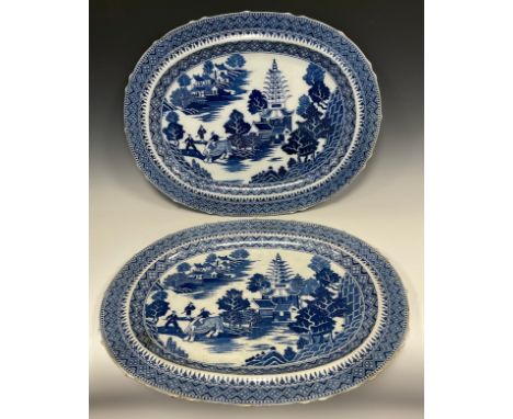 A pair of large English pearlware meat dishes, chinoiserie blue and white transfer print with depiction of an oriental landsc