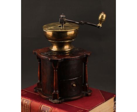 An 18th century oak country house coffee grinder or mill, iron crank, brass hopper, the architectural base with pillars to an