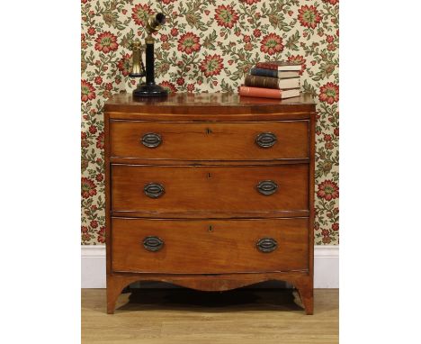 A Regency mahogany caddy top bowfront chest, of bachelor’s proportions and three long graduated drawers, serpentine apron, 78