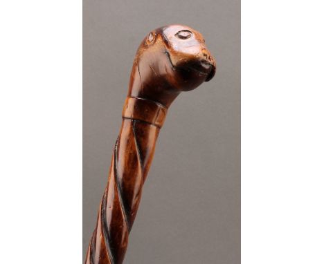 A 19th century folk art walking stick, the pommel carved as the head of a dog, the cane with entwined snake, 87.5cm long