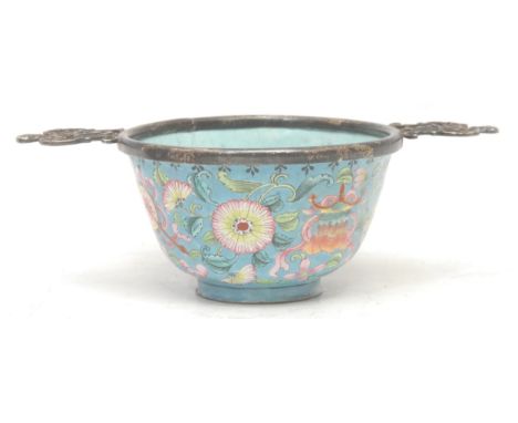 An 18th century Chinese enamel wine cup, English silver mounted as a quaich, painted in the typical Cantonese manner with flo