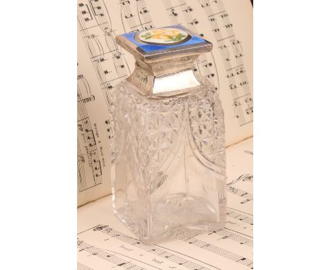 A George V silver and enamel mounted square scent bottle, hinged cover decorated with a yellow rose within a blue border, enc
