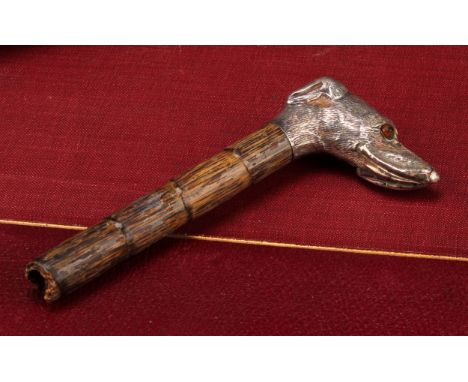 An early 20th century silver novelty parasol or walking stick handle, as the head of a dog, glass eyes, 4.5cm to tip of snout