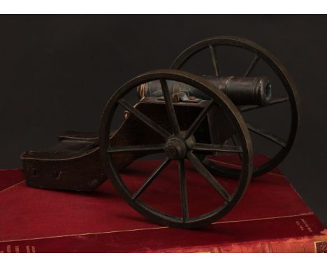 A bronze library model signalling cannon, 13cm barrel, the oak carriage with bronze wheels, 28cm long, early 20th century