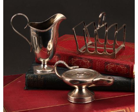 A Victorian silver helmet shaped cream jug, of George III design, square base, 11cm high, London 1897; a toast rack, Sheffiel