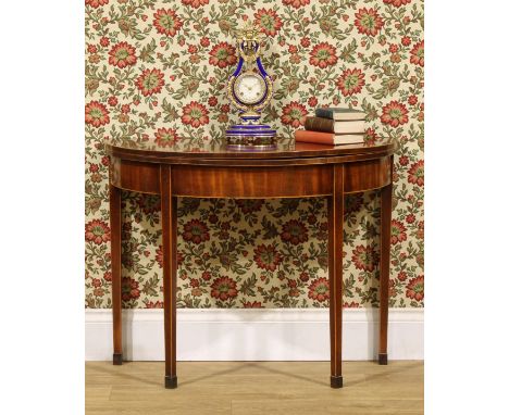 A George III mahogany demilune card table, outlined throughout with boxwood stringing, 73cm high, 94cm wide, 47cm deep, c.181