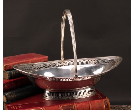 A George III silver navette shaped swing-handled cake basket, pierced and engraved in the Neo-Classical taste, 35cm wide, Mak