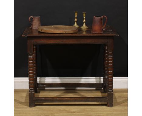 A Charles II oak side table, planked rectangular top, bobbin-turned supports, 67cm high, 84.5cm wide, 56.5cm deep, c.1680