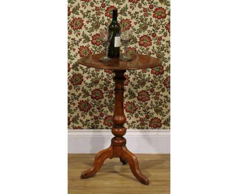 A Victorian walnut and parquetry tripod pedestal games table, the moulded circular top inlaid for chess, turned baluster pill