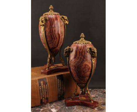 A pair of Neoclassical gilt bronze mounted alabastro fiorito ovoid urns, the mounts cast as caprine monopodia, 39.5cm high, c