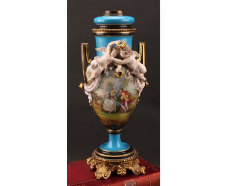A French porcelain two handled pedestal urnular oil lamp, in the manner of Sevres, painted in polychrome with gallant and his