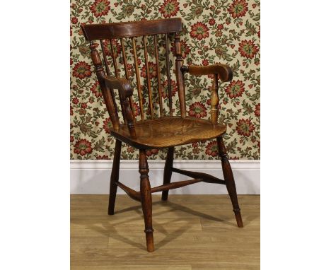 A 19th century vernacular elm and ash Windsor elbow chair, stick back with curved cresting rail flanked by turned supports, s