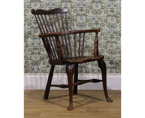 A 19th century vernacular beech, ash and elm Windsor comb back elbow chair, saddle seat, cabriole forelegs, 87cm high, 52cm w