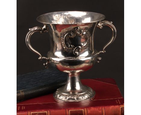 A Victorian silver campana two-handled pedestal cup, chased with a sporting trophy of hunting regalia and hanging game, acant