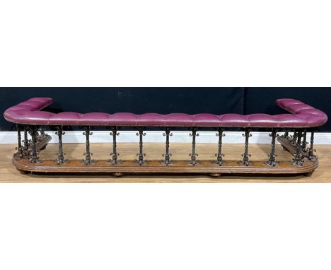 An Arts &amp; Crafts period oak and wrought iron club fender, 49.5cm high, 254.5cm wide, 92cm deep, c.1910
