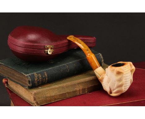 A 19th century carved meerschaum pipe, the bowl as an elephant mask with trunk extending in to the stem, bone tusks, amber mo