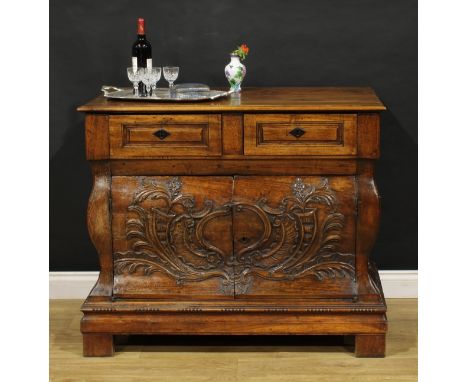 A 19th century French Provincial walnut bombe shaped press commode, rectangular top above a pair of frieze drawers and two do