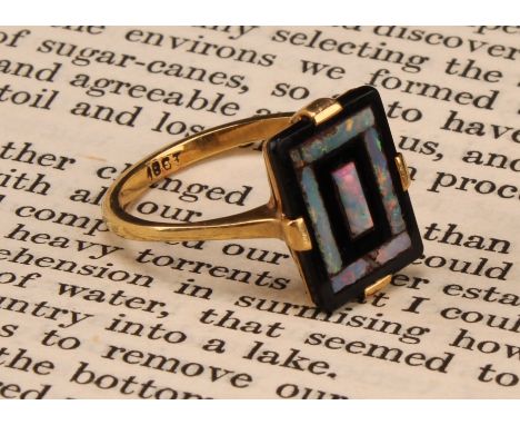 An 18ct gold art deco style opal and black onyx ring, with rectangular black onyx panel inlaid with with rectangular panels o