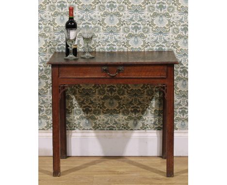 A George III oak side table, rectangular top above a long frieze drawer, apron brackets pierced in the Gothic Chippendale tas