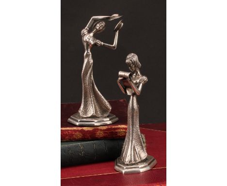 A pair of Continental silver figures, of young ladies reading, and playing cymbals, 13.5cm high, import mark for Mappin &amp;