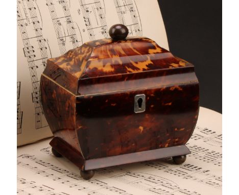 A George IV tortoiseshell sarcophagus tea caddy, of small proportions, hinged cover enclosing a lidded compartment, brass bal