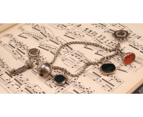 A Victorian silver bracelet suspending an oval carnelian seal stamp, with two doves beneath Vivons unis motto; two swivel fob