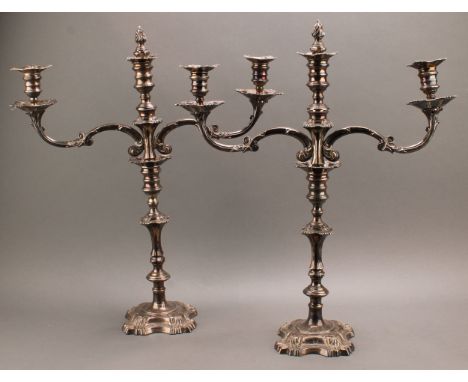 A pair of William IV Old Sheffield Plate three-light table candelabra, campana sconces, knopped pillars, shaped square bases 