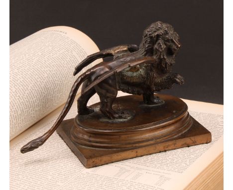 A 19th century dark patinated bronze Grand Tour desk weight, The Winged Lion of St Mark's Square, Venice, stepped oval base, 