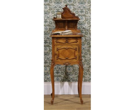 A late 19th century French walnut table de nuit, shaped back carved with acanthus and applied with a shelf, marble top above 