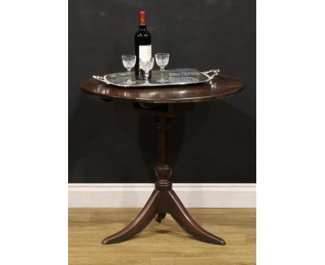 A George III vernacular mahogany and oak tripod supper table, circular tilting top on bird cage support, turned pillar, outsw