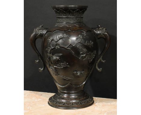 A large Japanese Meiji period bronze vase, of footed ovoid form, applied with paradise flycatchers and hummingbirds among blo