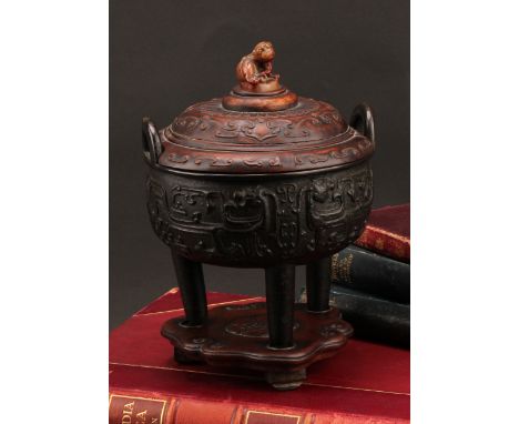 A Chinese bronze tripod censer, in the Archaic taste, hardwood cover with agate finial carved as a guardian lion, hardwood st