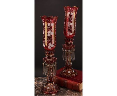 A pair of Bohemian cranberry flashed glass storm lantern candle lustres, decorated in opaque enamel and gilt, 54.5cm high, c.