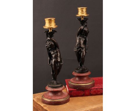 A pair of 19th century brown patinated bronze figural candlesticks, gilt sconces, turned marble bases, 28cm high, c.1880