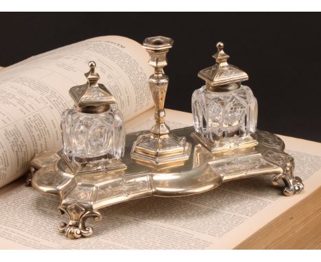 A Victorian silver shaped rectangular inkstand, the pair of lancet cut clear glass wells with square hinged pagoda covers, di