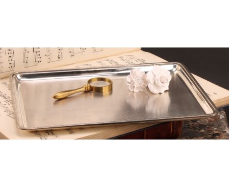 A George V silver rounded rectangular dressing table tray, engine turned, 28cm wide, Mappin &amp; Webb, London 1913, 564g