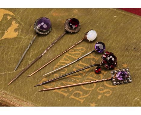 Stick Pins - a late 19th century 9ct rose gold pin, set with a single polished opal cabochon, 5.5cm, 0.9g; an unmarked pin se
