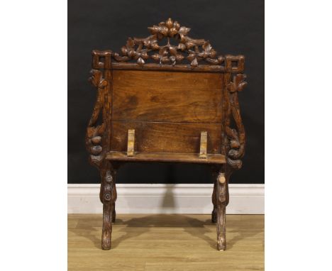 A Black Forest fire screen, carved with a border of leafy branches, downswept rustic feet, 82cm high, 60cm wide, early 20th c