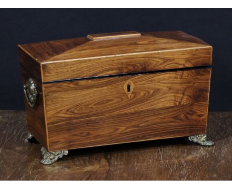 A Regency rosewood sarcophagus tea caddy, hinged cover enclosing removable hinged covered compartments, gilt metal paw feet, 